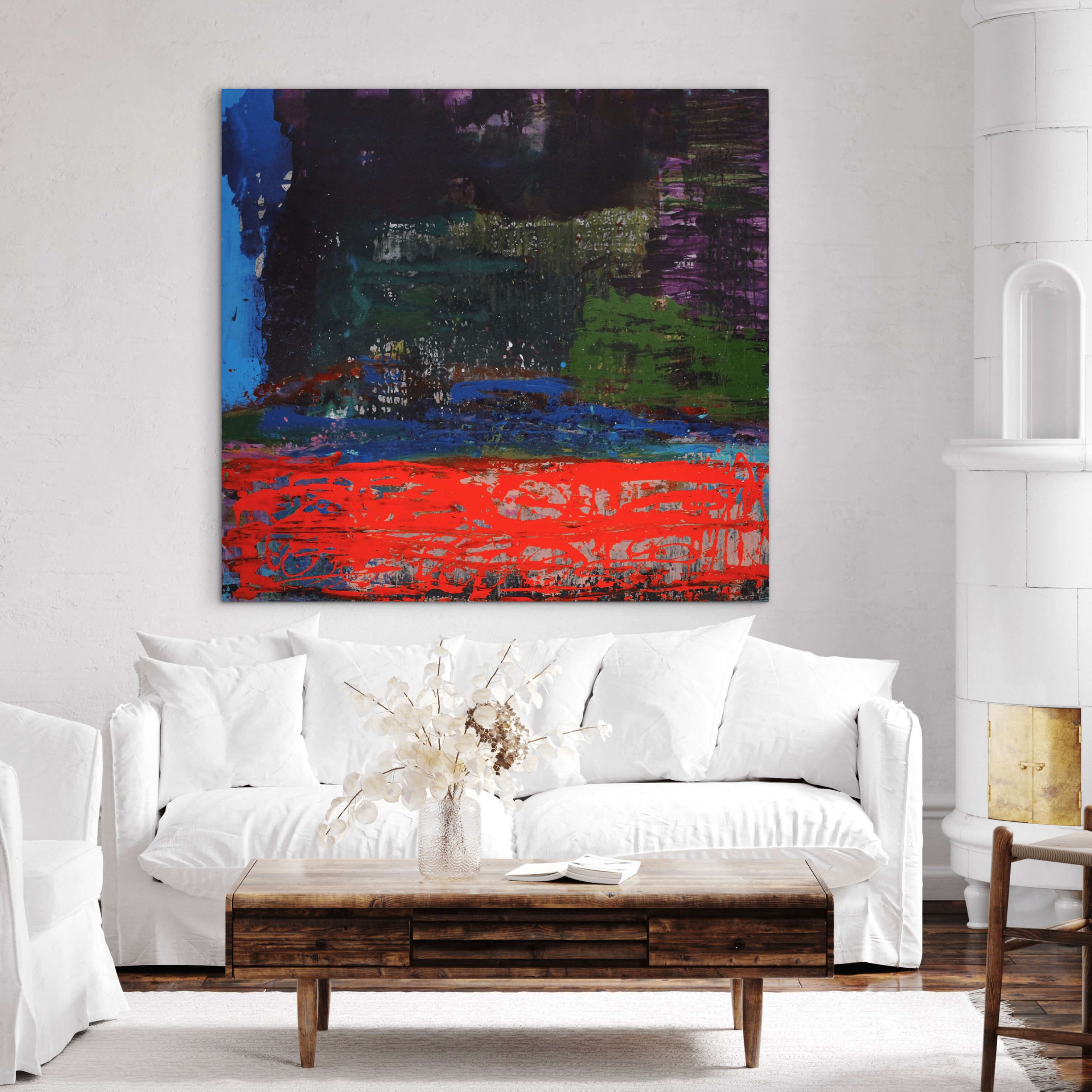 Modern living room with a white sofa, wooden coffee table, and abstract painting on the wall.