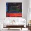 Modern living room with a white sofa, wooden coffee table, and abstract painting on the wall.
